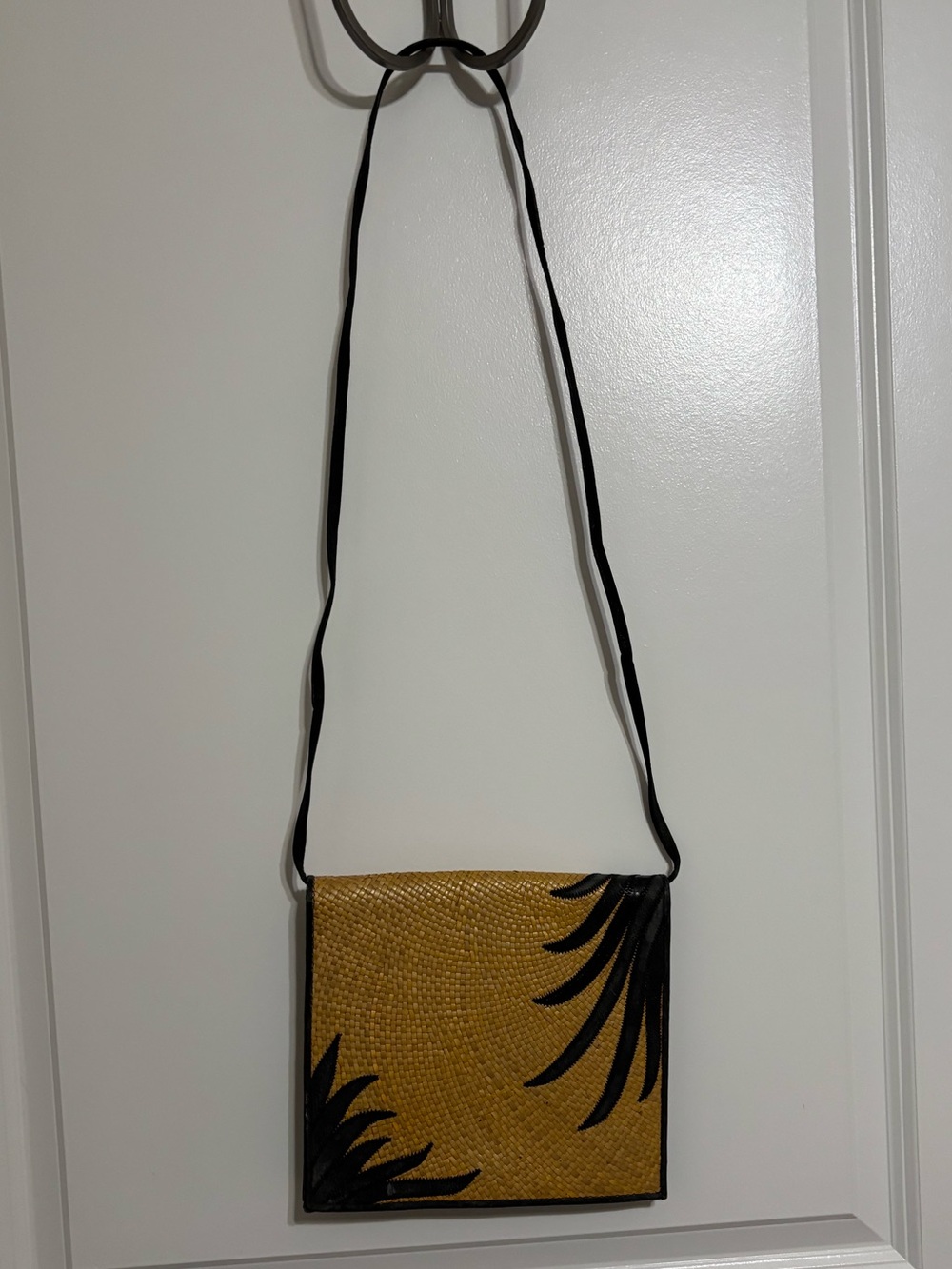 LISETTE woven textured crossbody bag with Black Leaf Detail